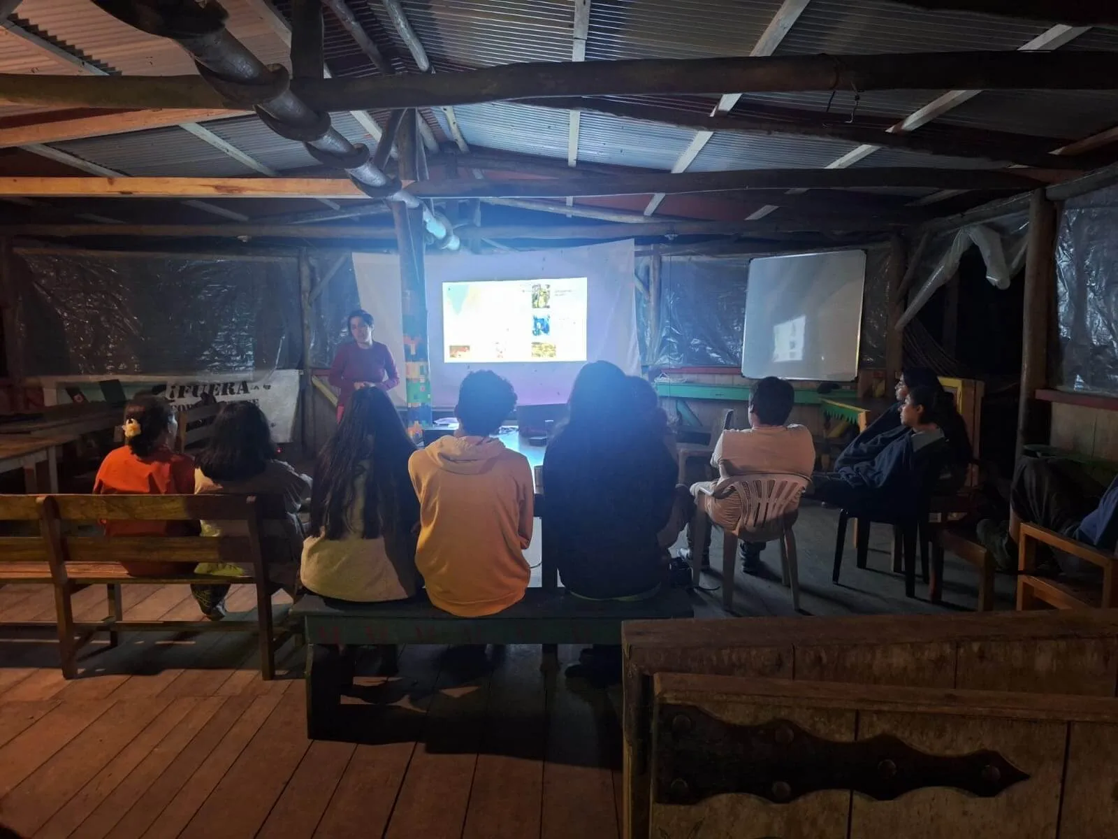 Pontifical Catholic University of Ecuador students receiving academic presentation at night at the Los Cedros Scientific Station