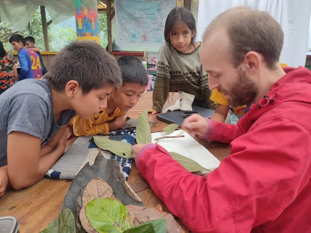 Children learn about samples of Lauraceae plants collected at Los Cedros Scientific Station by botanist Tom Wells