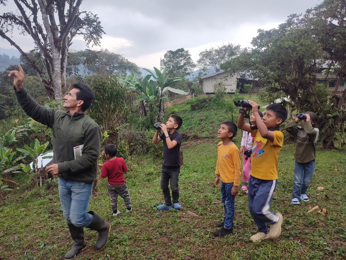 Local schoolchildren on field trip to Los Cedros Protected Forest birdwatching with a Scientific Station ranger